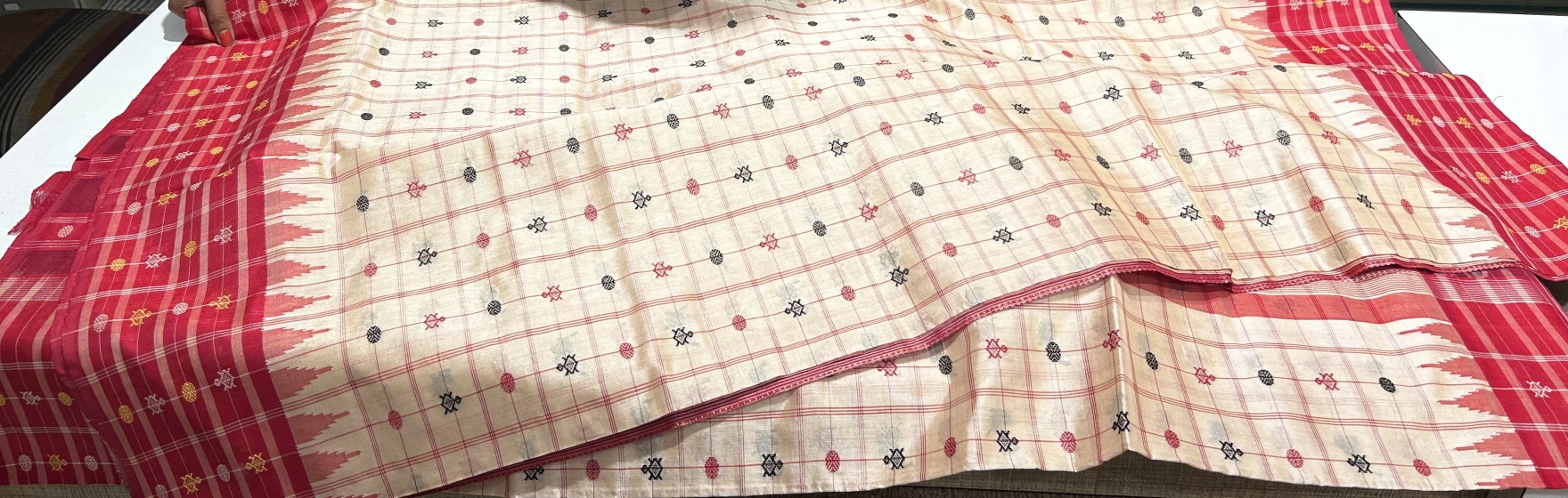 Intricate turtle butis motifs on body n border adorned with traditional ikat Aanchal Bapta Saree 